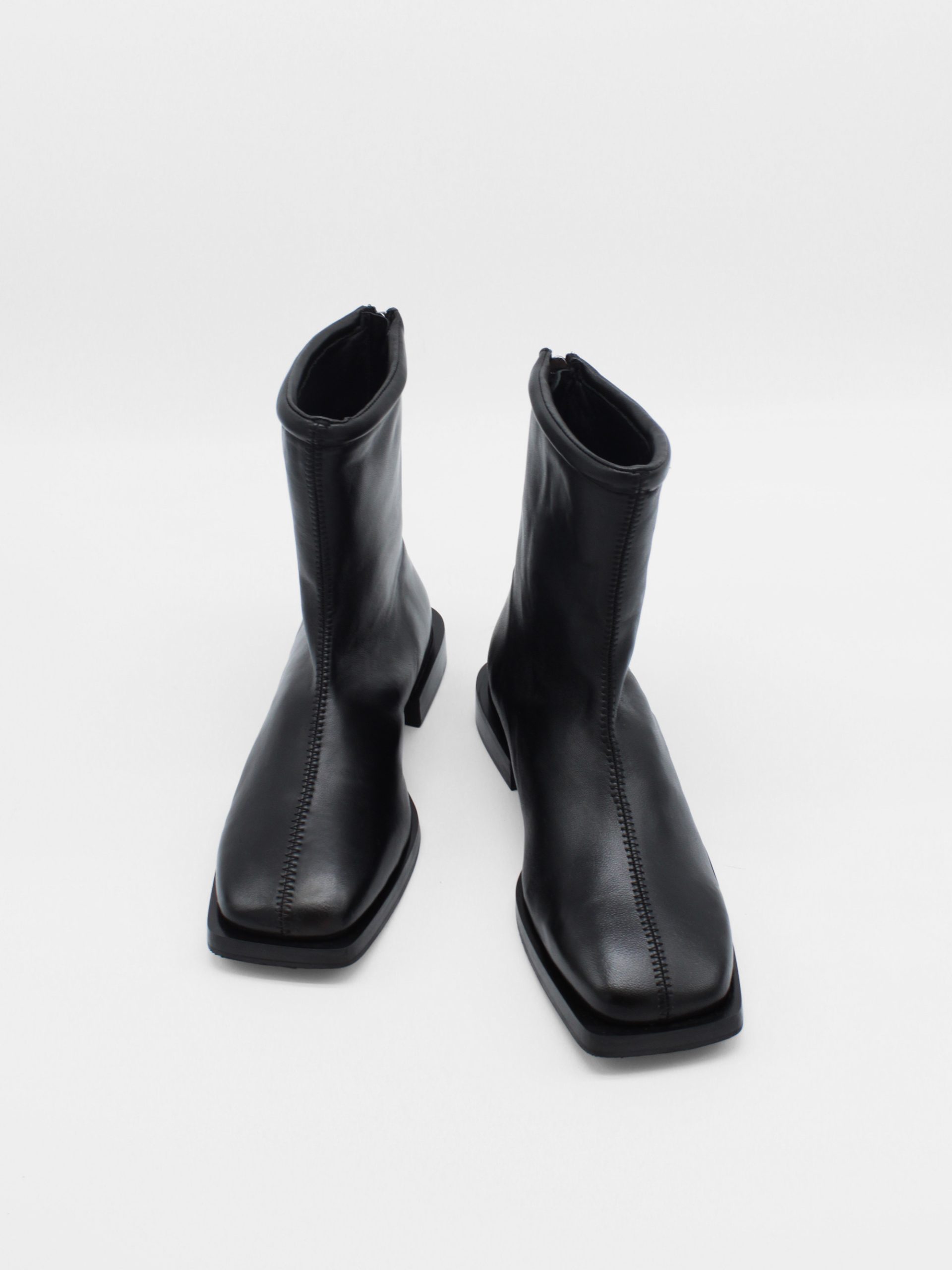 ankle boots in black by about arianne