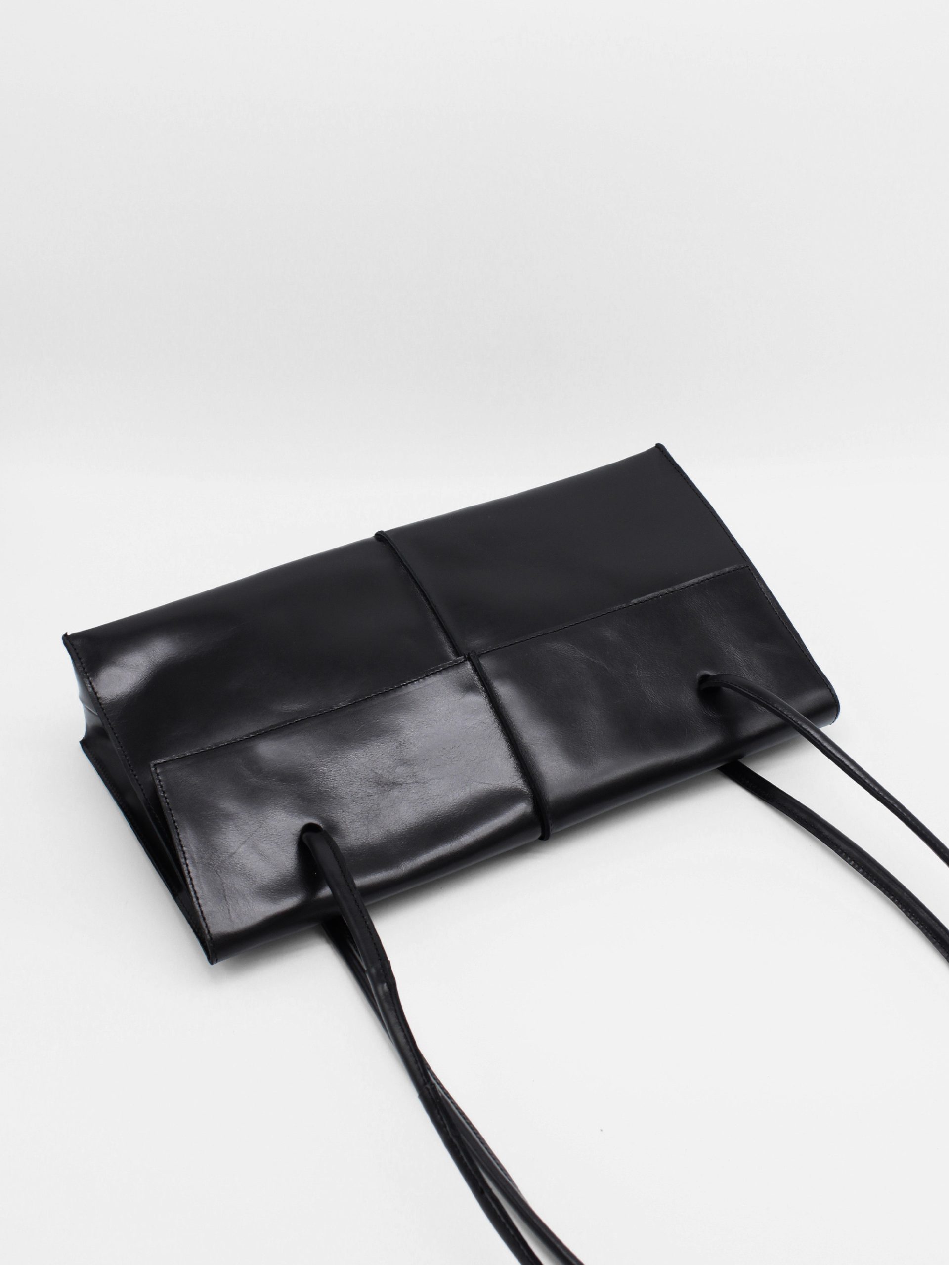 rectangle leather shoulder bag with string straps in black