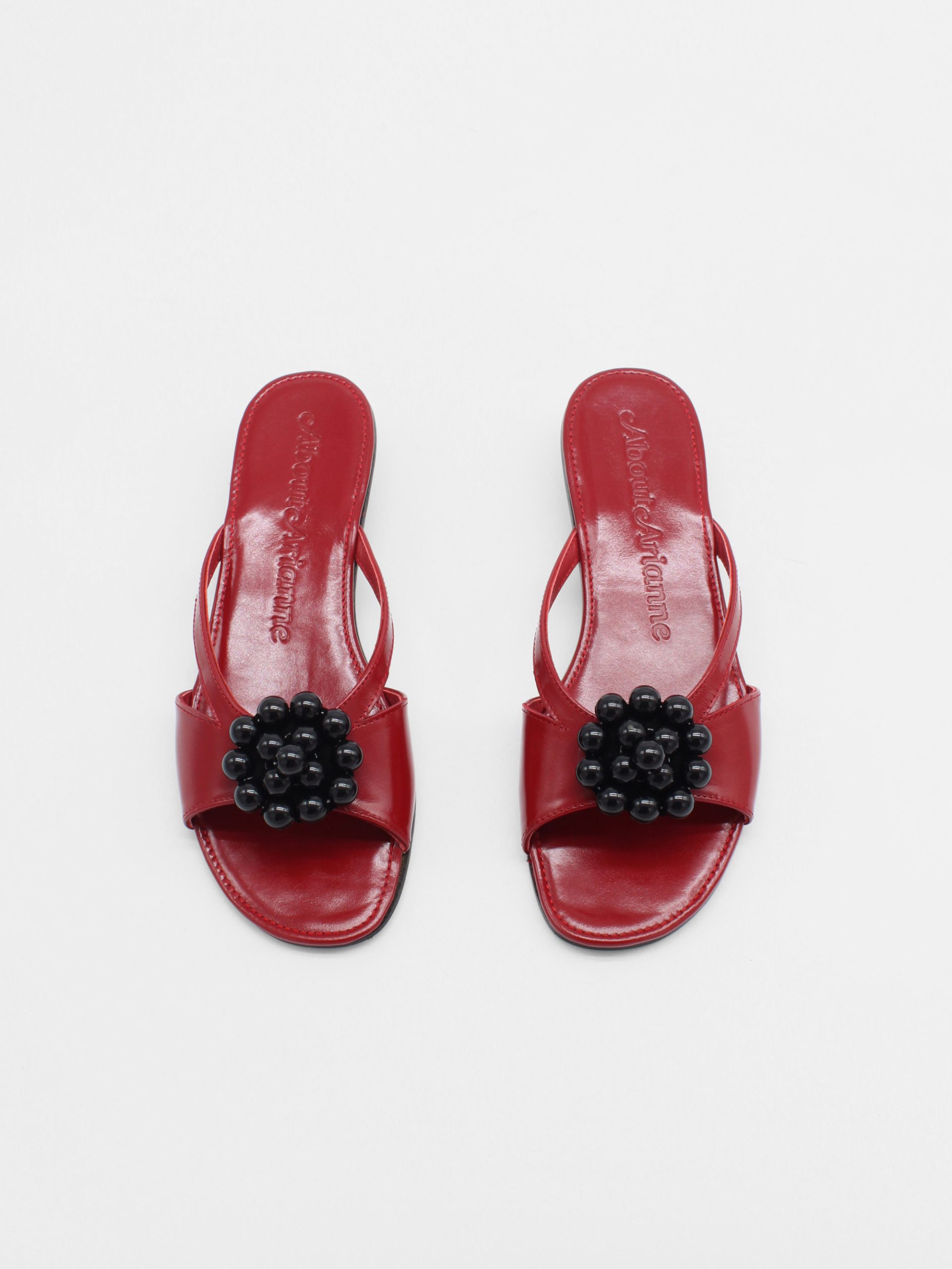 Red kitten heels with beaded ornament in black by about arianne