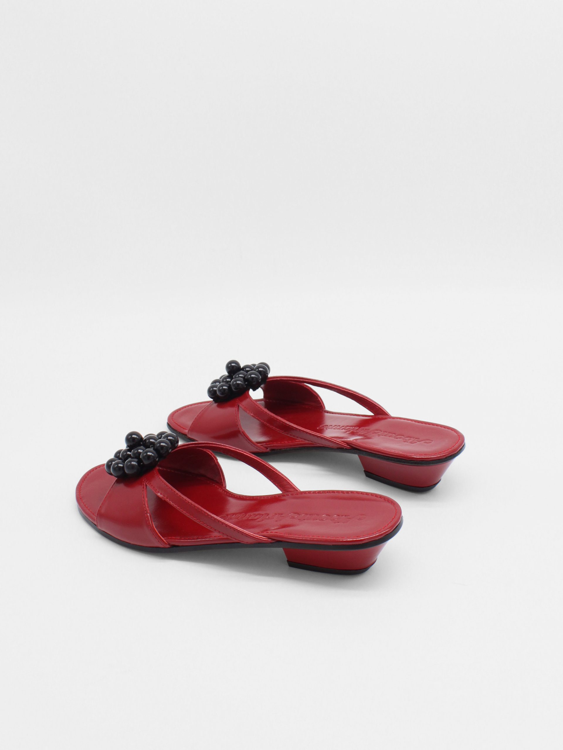 Red kitten heels with beaded ornament in black by about arianne