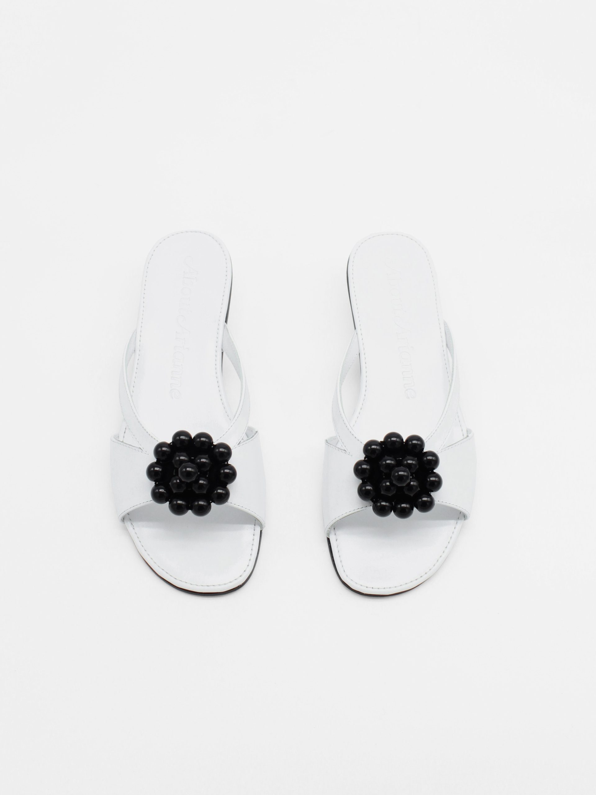 White kitten heels with beaded ornament in black by about arianne