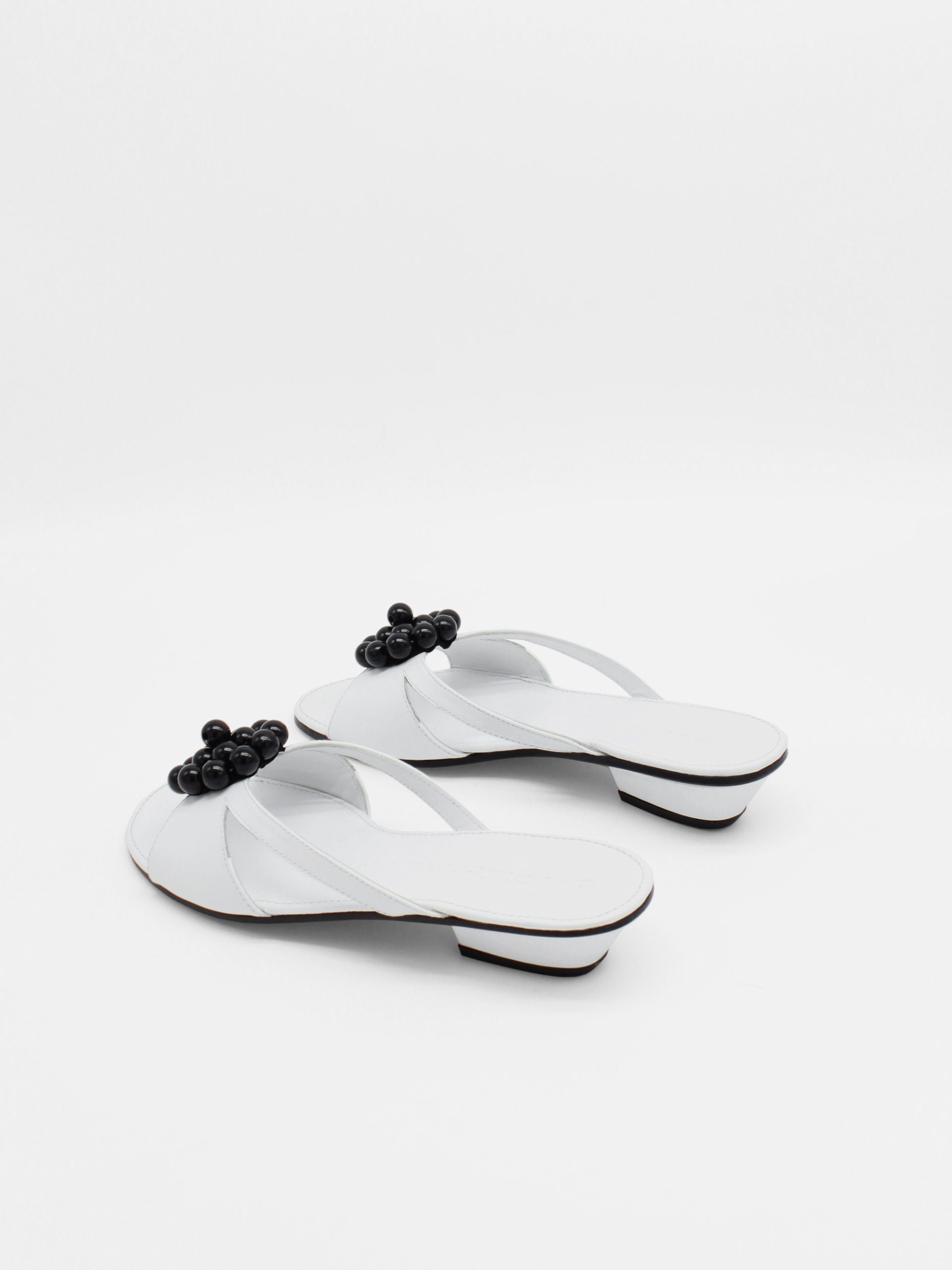 White kitten heels with beaded ornament in black by about arianne