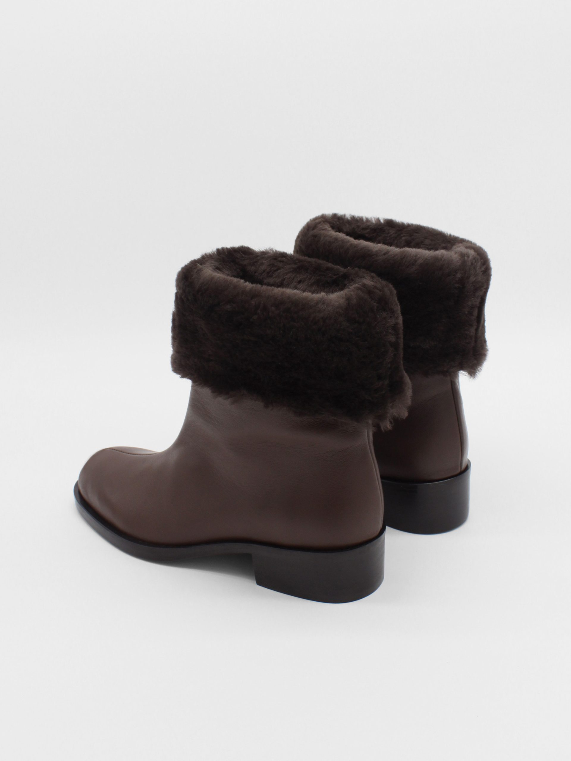 fur lined mid rise boots in brown leather