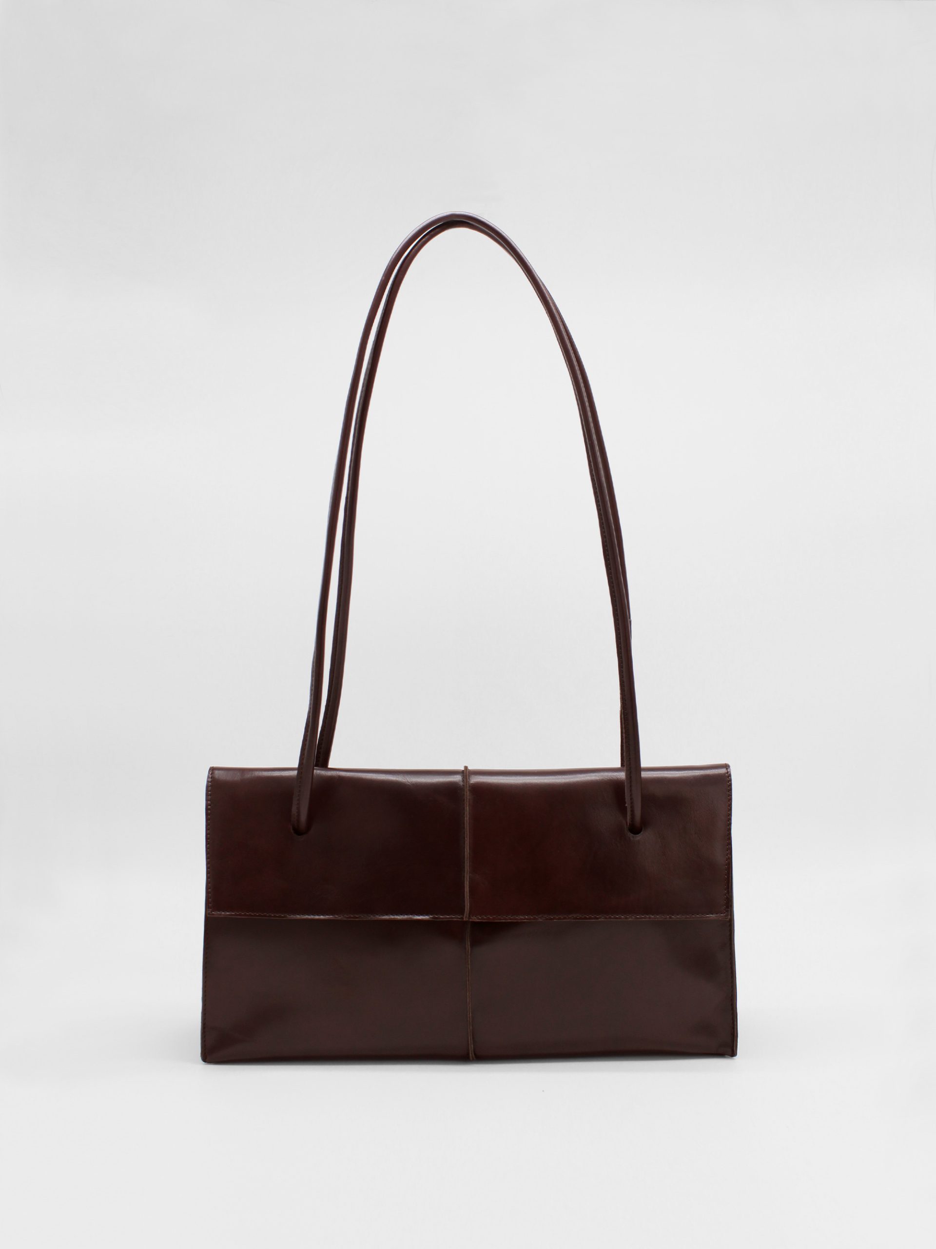 Big rectangle leather shoulder bag with string straps in brown